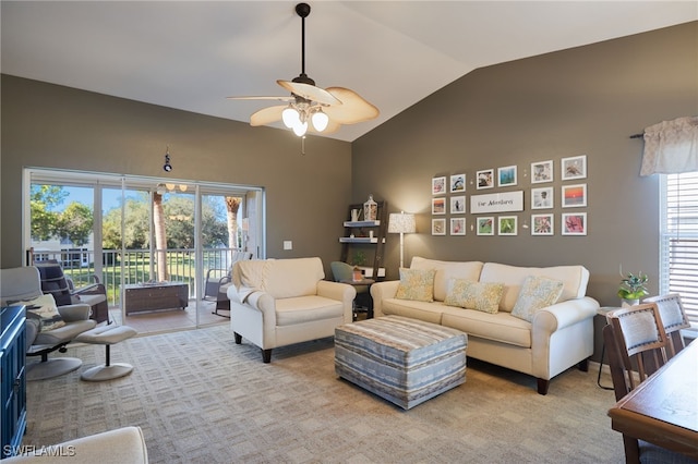 living room with ceiling fan, light colored carpet, and lofted ceiling