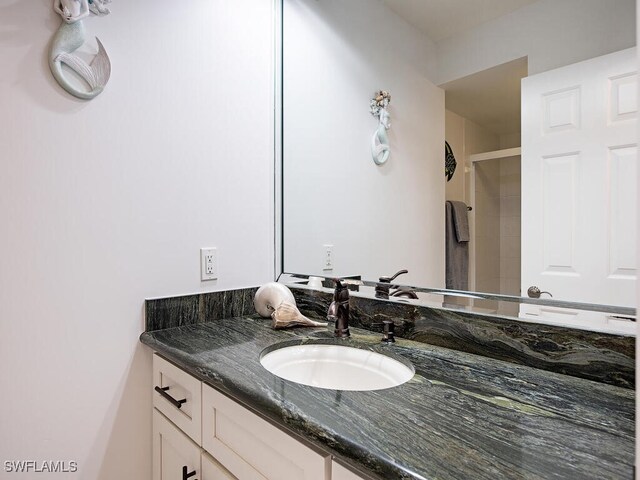 bathroom featuring vanity and a shower