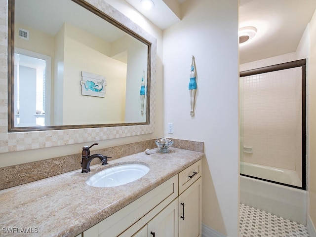 bathroom featuring vanity and enclosed tub / shower combo