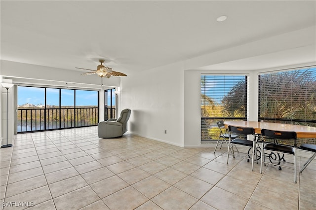 interior space featuring a water view, plenty of natural light, and ceiling fan