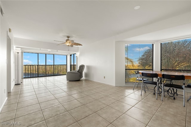 living area featuring ceiling fan and light tile patterned floors