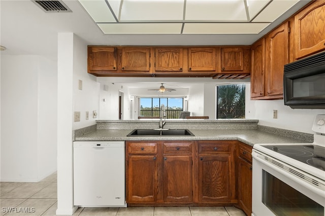 kitchen with ceiling fan, sink, light tile patterned flooring, and white appliances