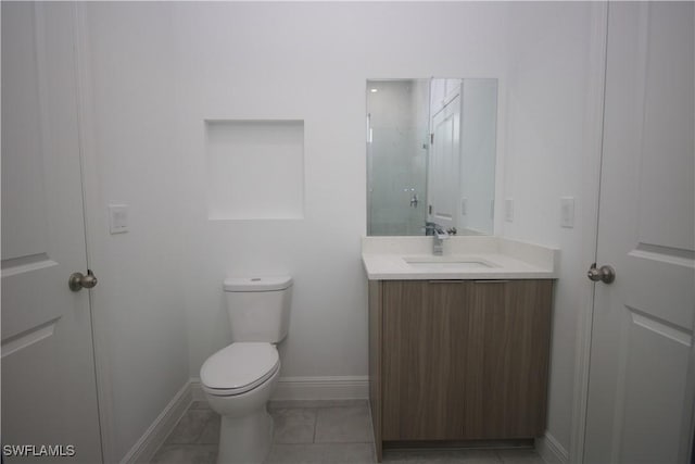 bathroom with tile patterned floors, vanity, and toilet