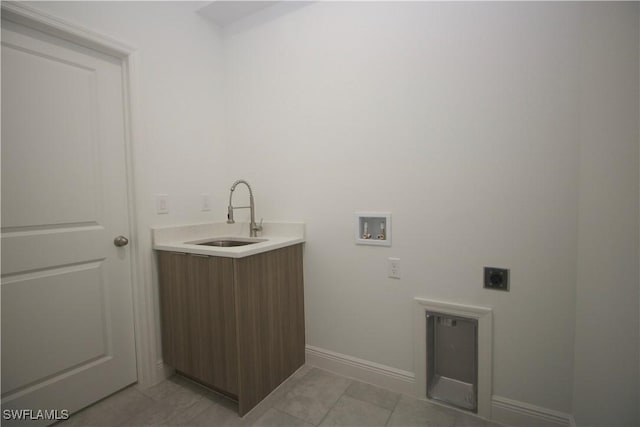 clothes washing area with electric dryer hookup, light tile patterned floors, sink, and hookup for a washing machine