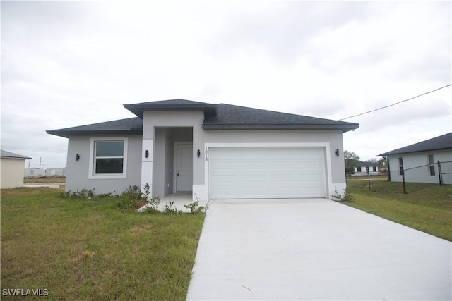 view of front of home featuring a garage and a front lawn