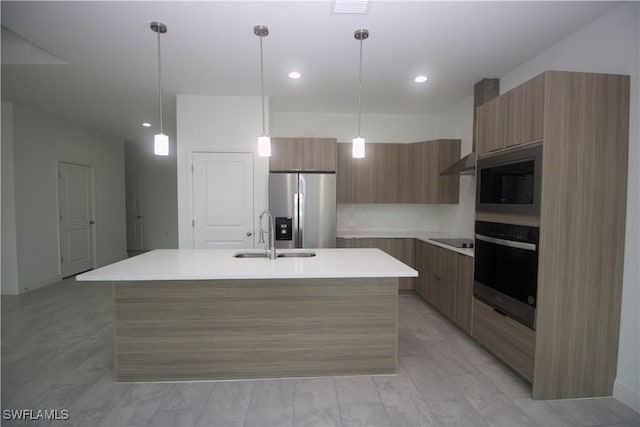 kitchen featuring sink, a center island with sink, pendant lighting, and appliances with stainless steel finishes