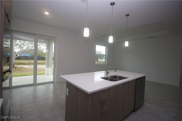 kitchen featuring dishwasher, sink, an island with sink, and a healthy amount of sunlight