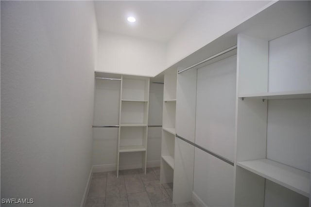 spacious closet featuring light hardwood / wood-style floors