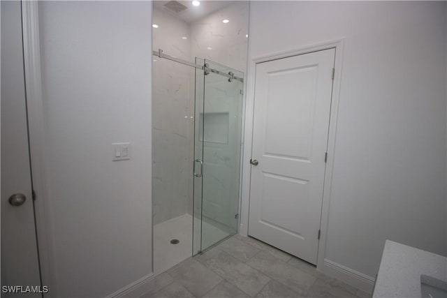 bathroom featuring a shower with door