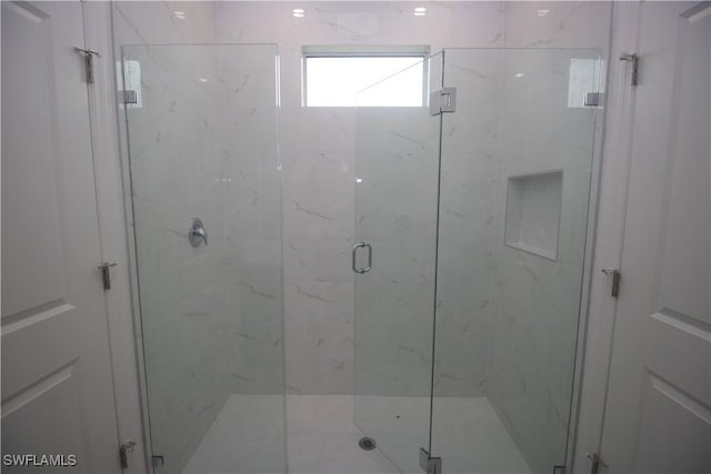 bathroom with a shower with shower door