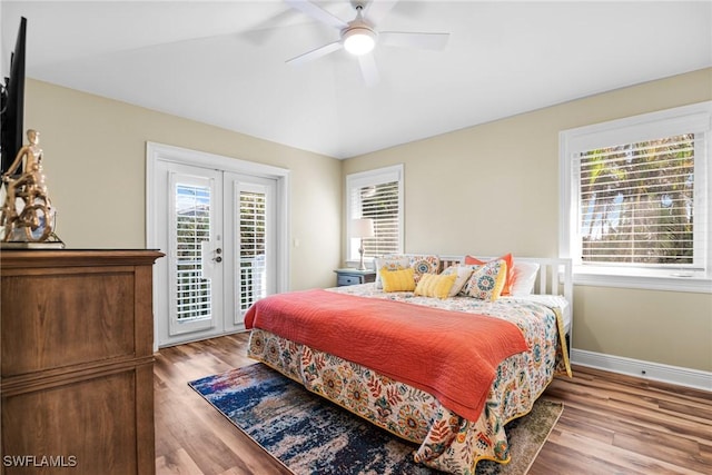 bedroom with access to exterior, french doors, light wood-type flooring, and ceiling fan