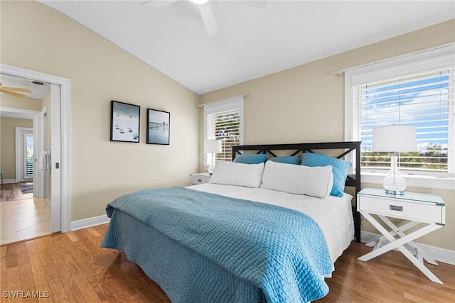 bedroom featuring wood-type flooring, vaulted ceiling, and ceiling fan