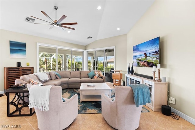 living room featuring ceiling fan, light tile patterned flooring, and vaulted ceiling