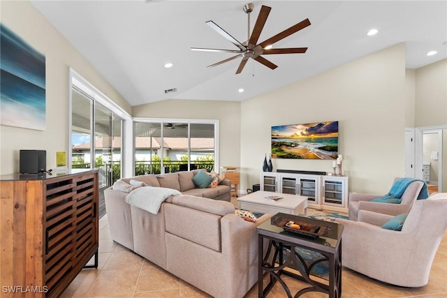 living room with ceiling fan, light tile patterned floors, a healthy amount of sunlight, and vaulted ceiling