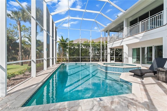 view of swimming pool featuring a lanai, an in ground hot tub, and a patio