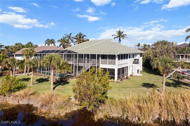 rear view of house featuring a lawn