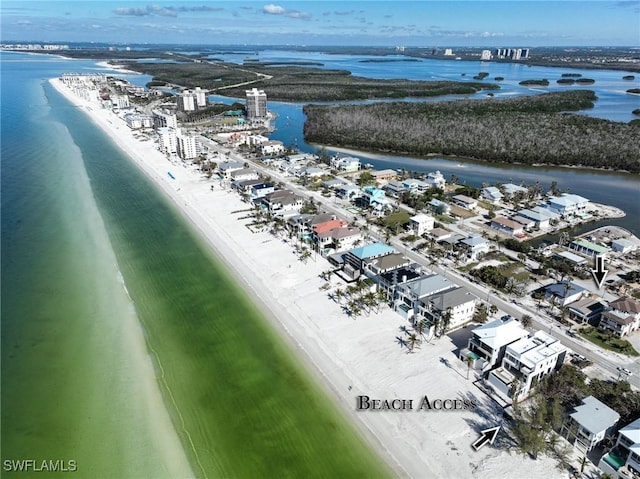 bird's eye view with a water view and a beach view