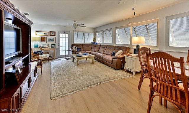 living room with ceiling fan and light hardwood / wood-style floors