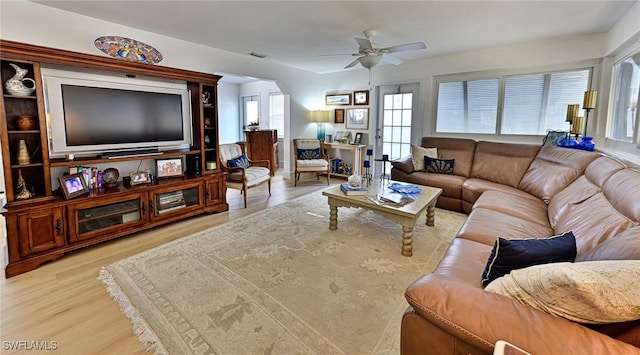 living room featuring ceiling fan and light hardwood / wood-style floors