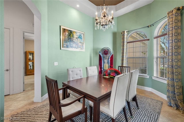 dining space featuring light tile patterned floors, an inviting chandelier, and plenty of natural light