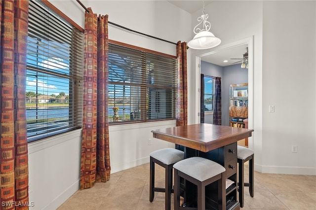 dining area featuring light tile patterned floors and ceiling fan