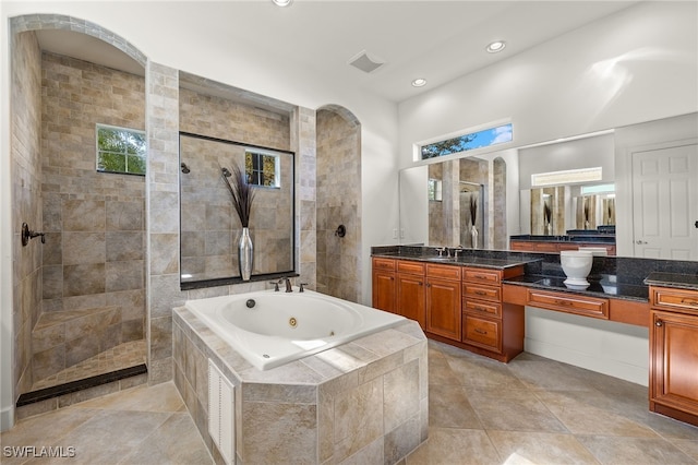 bathroom with tile patterned floors, vanity, and separate shower and tub