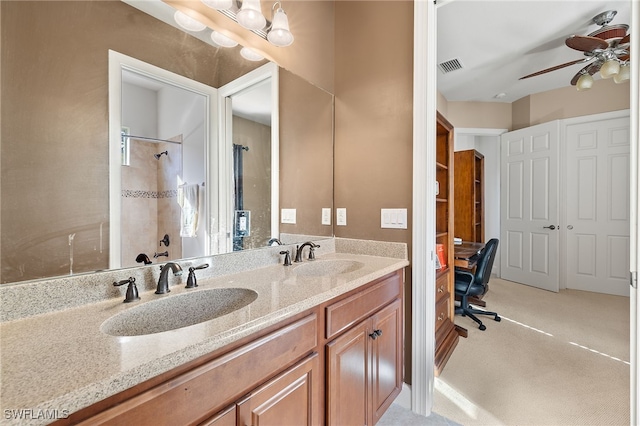 bathroom with vanity, ceiling fan, and tiled shower