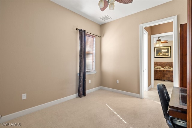 unfurnished office with ceiling fan and light colored carpet