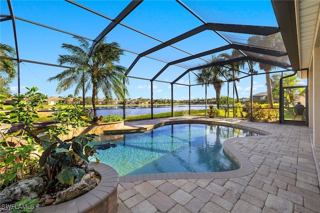 view of swimming pool featuring a lanai, a patio area, and a water view