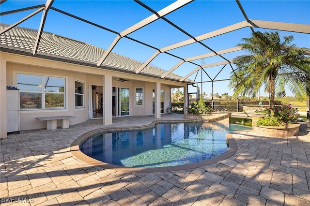 view of pool featuring ceiling fan, a lanai, and a patio