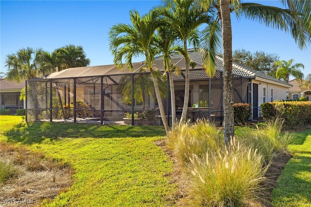 view of yard with glass enclosure