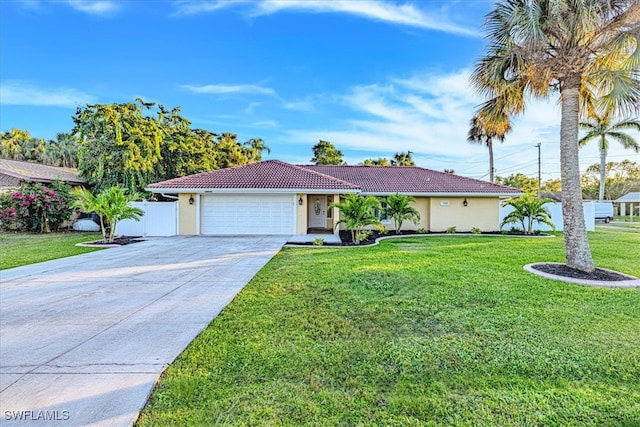 ranch-style home featuring a front lawn and a garage