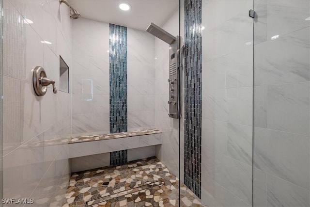 bathroom with a tile shower