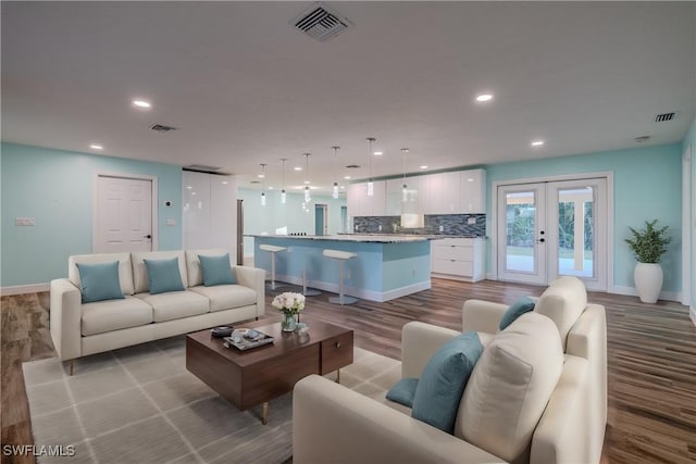 living room featuring french doors and light hardwood / wood-style floors