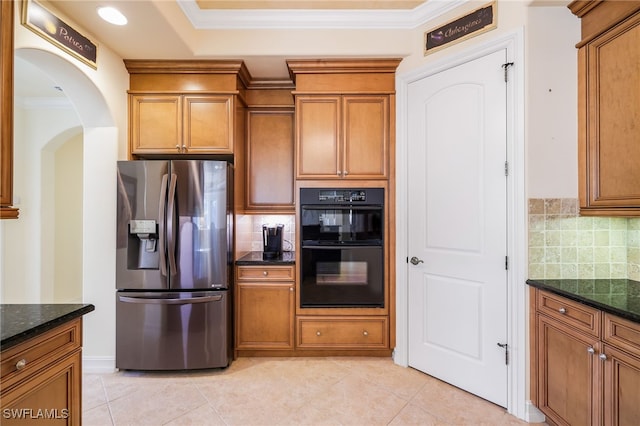 kitchen featuring decorative backsplash, stainless steel fridge with ice dispenser, black double oven, and dark stone counters