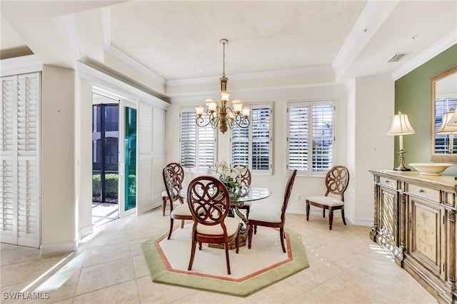 tiled dining space featuring crown molding and an inviting chandelier