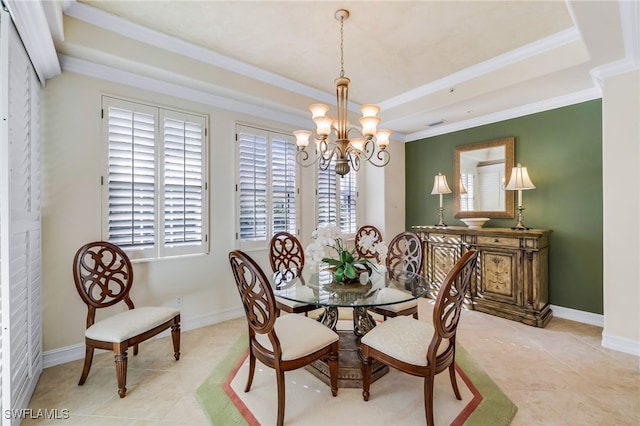 tiled dining room featuring a tray ceiling, a chandelier, and ornamental molding