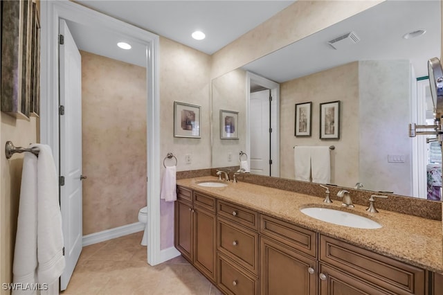 bathroom featuring tile patterned floors, vanity, and toilet