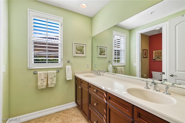 bathroom featuring toilet, vanity, and tile patterned floors