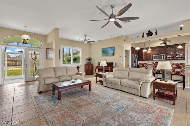 living room featuring ceiling fan and french doors