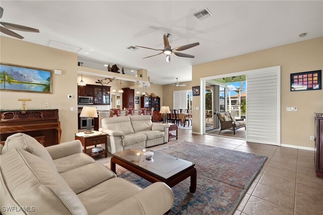 tiled living room with ceiling fan