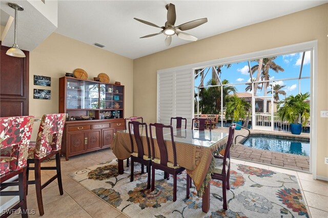 tiled dining space featuring ceiling fan