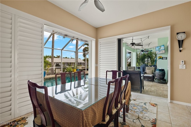 tiled dining area featuring ceiling fan