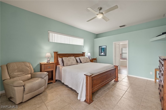 tiled bedroom with connected bathroom and ceiling fan