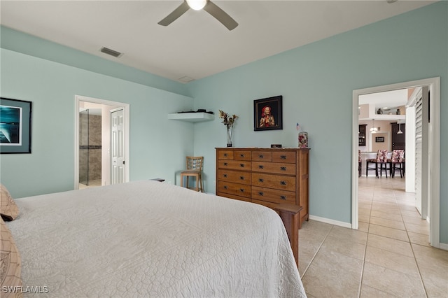 tiled bedroom featuring ceiling fan and ensuite bathroom