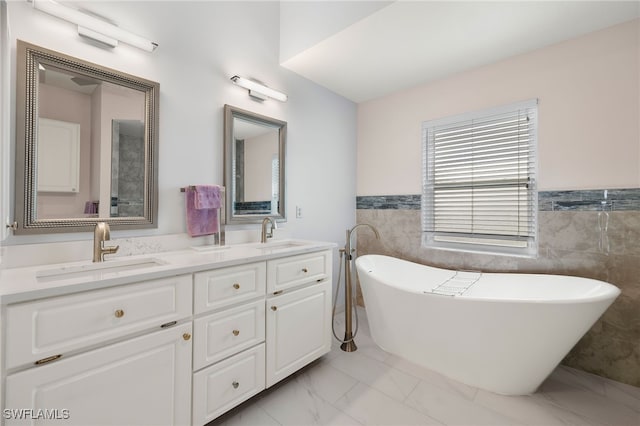 bathroom featuring vanity, tile walls, and a tub