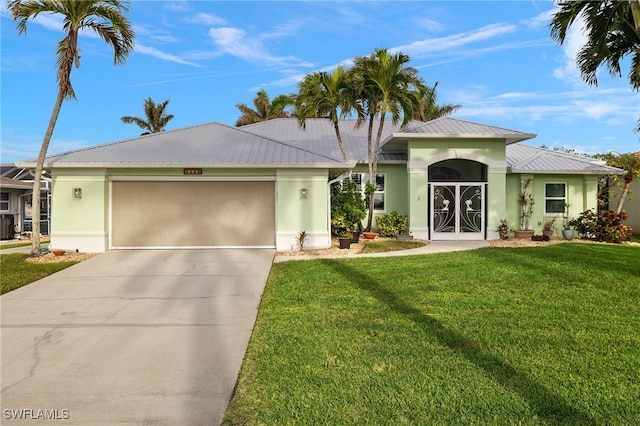 ranch-style house with central air condition unit, french doors, a front lawn, and a garage