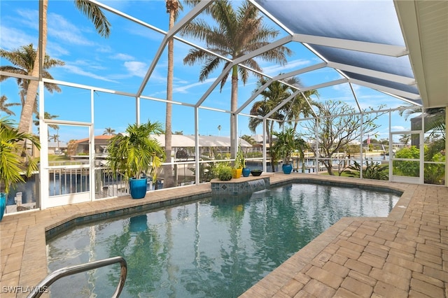 view of pool with a patio and glass enclosure