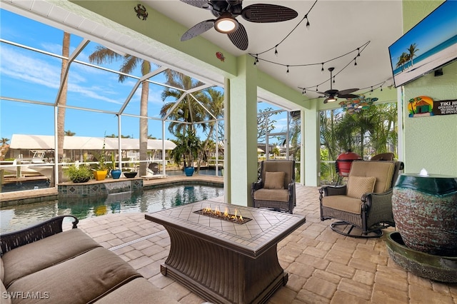 view of patio / terrace featuring ceiling fan and a lanai