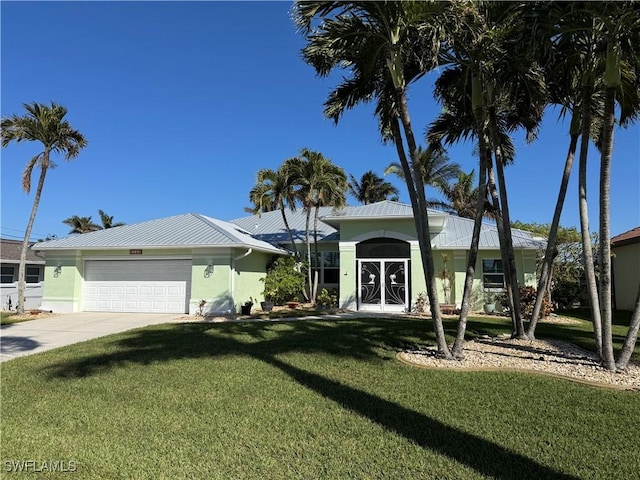 view of front of house featuring french doors, a garage, and a front lawn